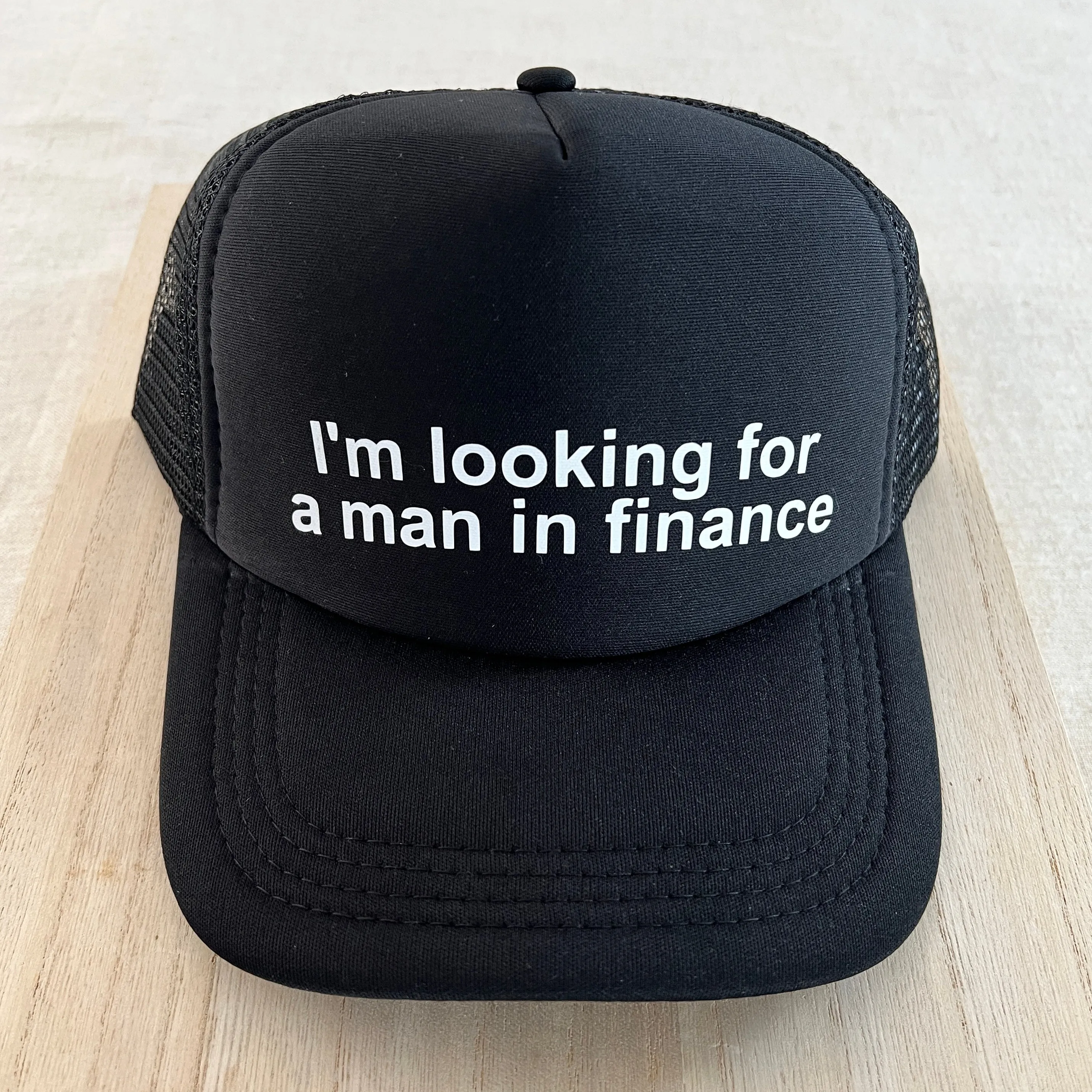 Looking For A Man In Finance Trucker Hat - Black